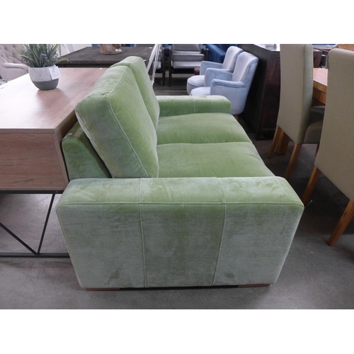 1373 - A lime green velvet two seater sofa