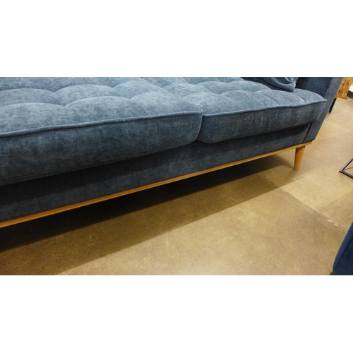 1380 - A Nero blue fabric three seater sofa on semi exposed timber frame