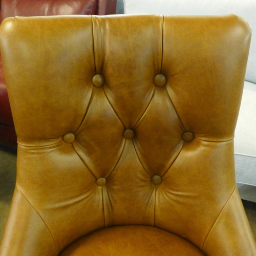 1351 - A Cerato leather and studded chair