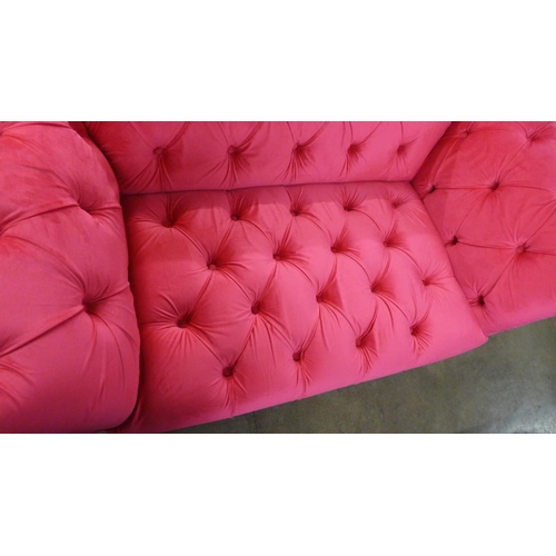 1401 - A hot pink upholstered two seater Chester club sofa with grey oak legs