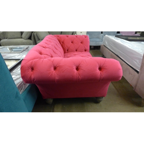 1401 - A hot pink upholstered two seater Chester club sofa with grey oak legs