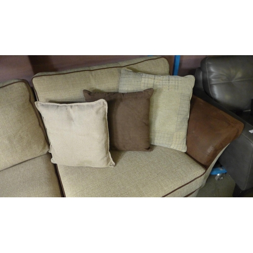 1655 - A tan and oatmeal upholstered three seater sofa