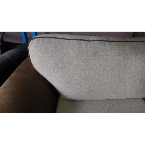 1655 - A tan and oatmeal upholstered three seater sofa