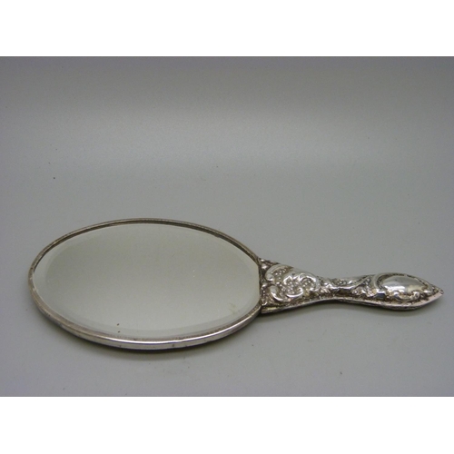 831 - A silver backed mirror, marked .90, 16.5cm