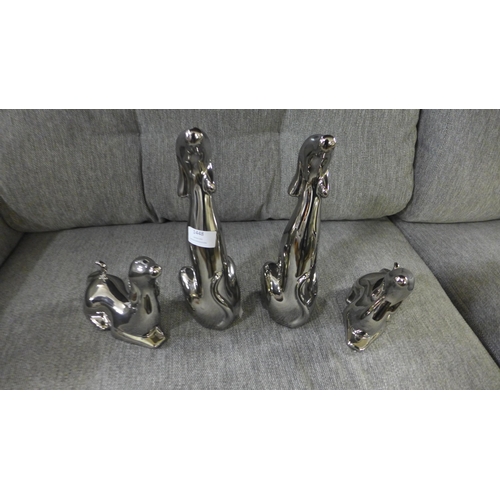 1443 - A set of four silver ornamental dogs