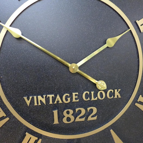 1450 - A large round embossed black and gold wall clock, H79cms (CL215238)   #