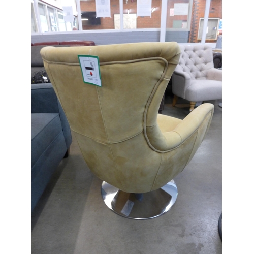 1301 - A mustard suede upholstered swivel armchair with a chrome base  *This lot is subject to VAT