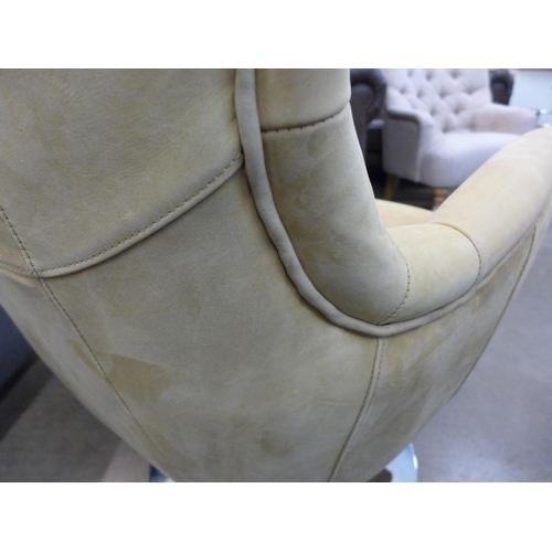 1301 - A mustard suede upholstered swivel armchair with a chrome base  *This lot is subject to VAT