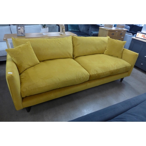 1311 - A Turmeric velvet upholstered four seater sofa