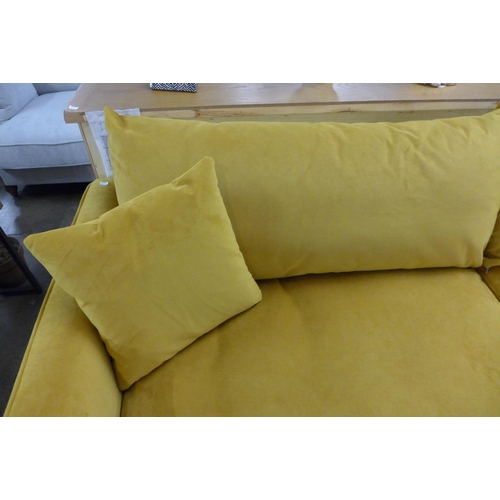 1311 - A Turmeric velvet upholstered four seater sofa