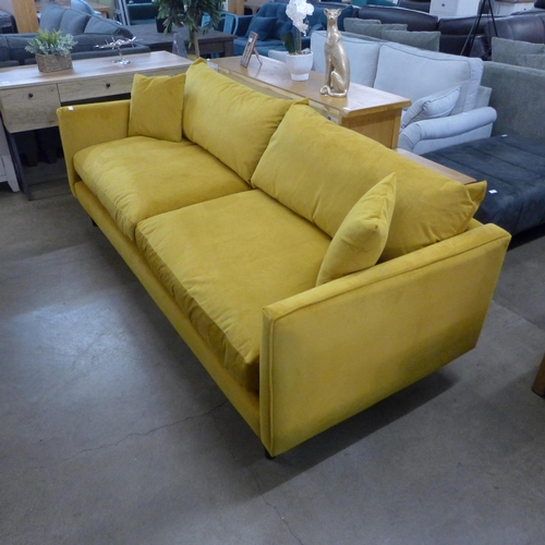 1311 - A Turmeric velvet upholstered four seater sofa