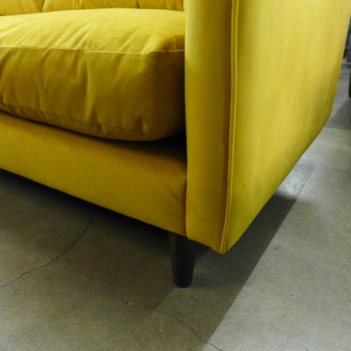 1311 - A Turmeric velvet upholstered four seater sofa