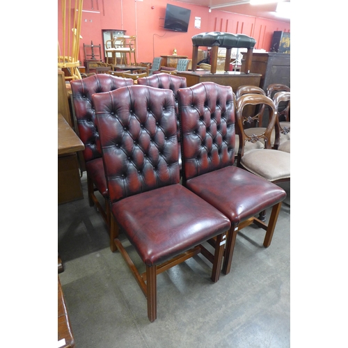 148 - A set of four mahogany and red leather button back dining chairs