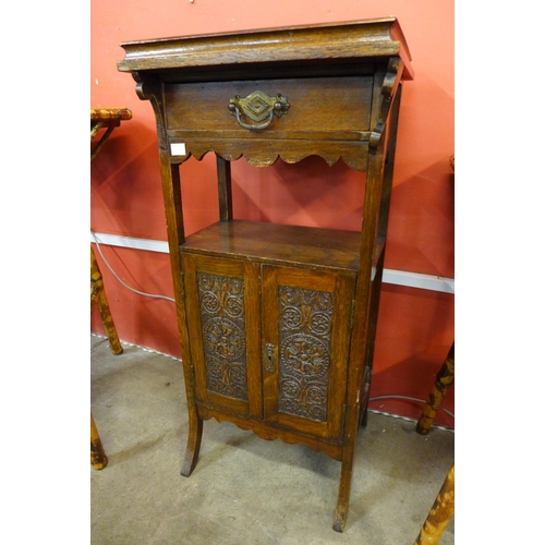 149 - An Edward VII carved oak smokers cabinet