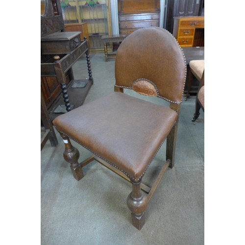 220 - A set of four Art Deco oak and faux leather chairs