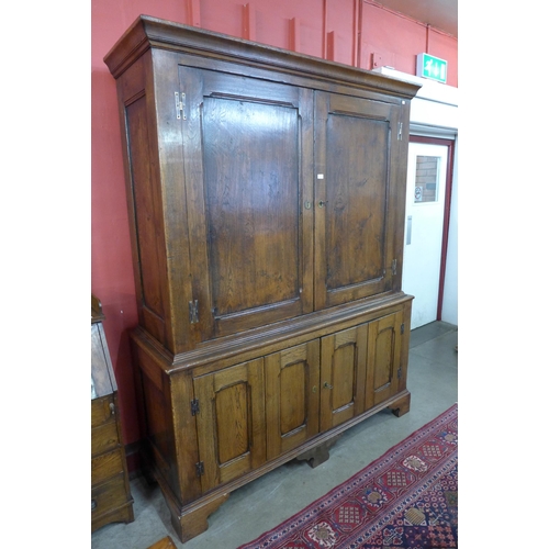 1 - A George III style oak housekeeper's cupboard, 220cms h, 172cms w, 56cms d