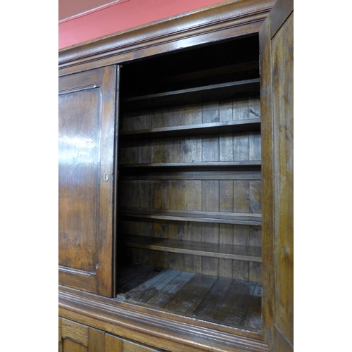 1 - A George III style oak housekeeper's cupboard, 220cms h, 172cms w, 56cms d