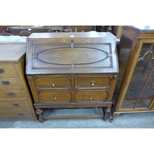 107 - A carved oak bureau