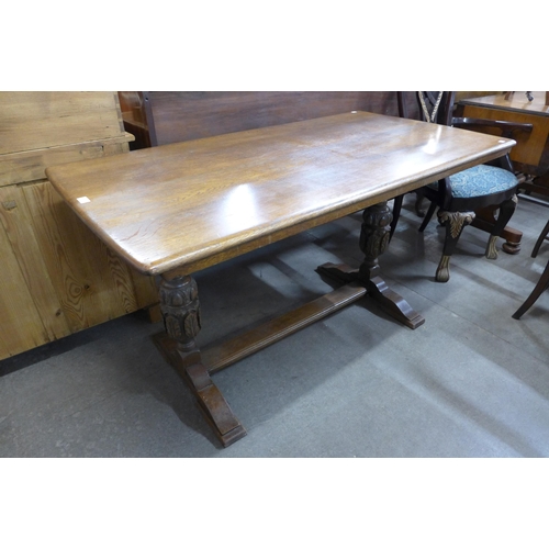 136 - A carved oak refectory table