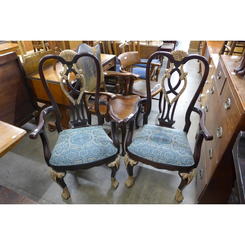 137 - A pair of French Empire style mahogany and parcel gilt armchairs