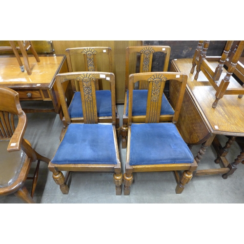 142 - A set of four carved oak dining chairs