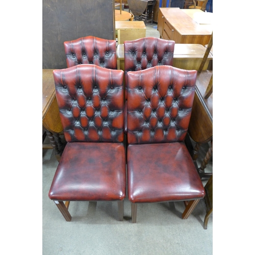 148 - A set of four mahogany and red leather button back dining chairs