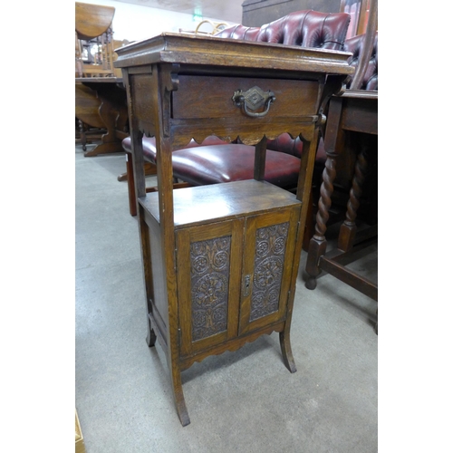 149 - An Edward VII carved oak smokers cabinet