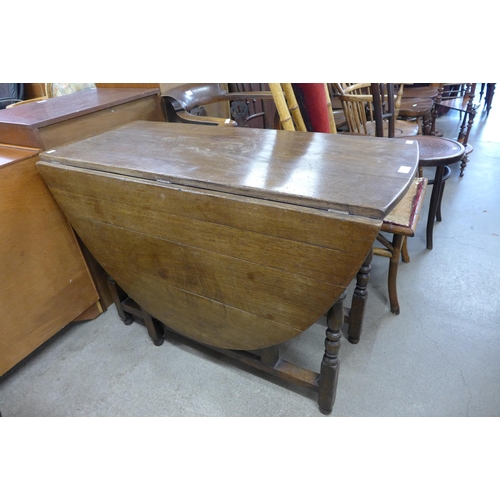 156 - A George II style oak gateleg dining table