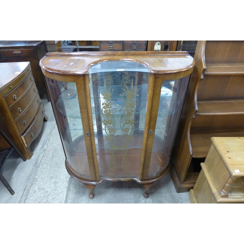 191 - A walnut serpentine display cabinet