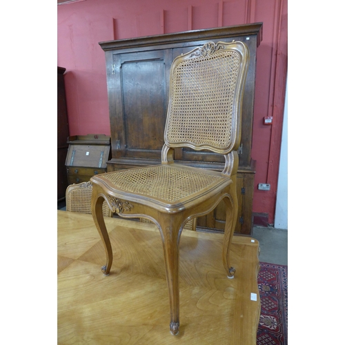 2 - A French cherry wood extending dining table (75cms h, 169cms l, 94cms w) and six bergere chairs