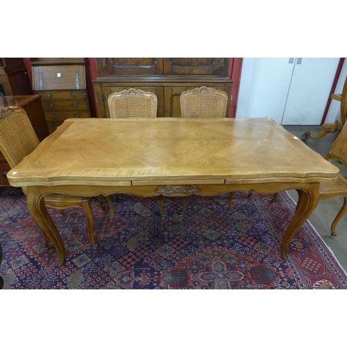 2 - A French cherry wood extending dining table (75cms h, 169cms l, 94cms w) and six bergere chairs