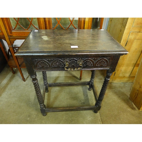 211 - A Victorian Jacobean Revival carved oak single drawer side table