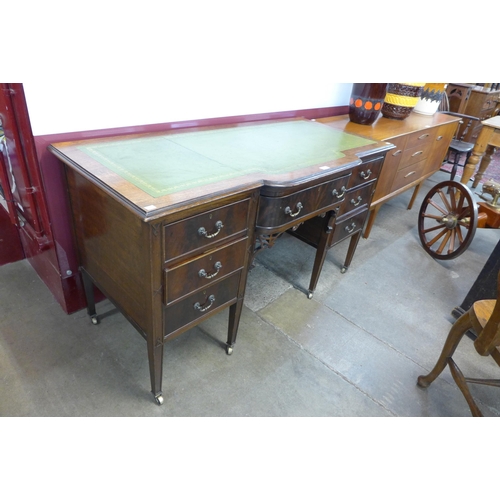 22 - An Edward VII mahogany and green leather topped breakfront desk