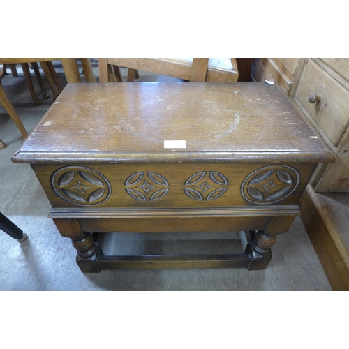 232 - A small carved oak sewing box, an oak occasional table and a teak occasional table