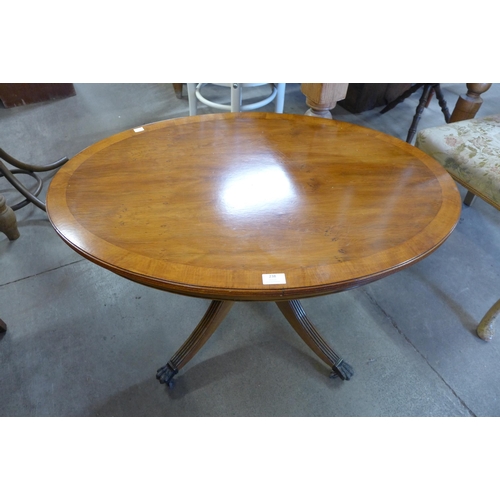 238 - An oval yew wood coffee table and a French painted chair