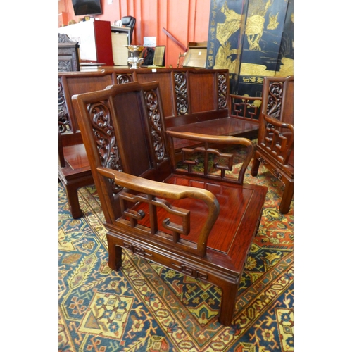 41 - A Chinese carved hardwood settee and a pair of armchairs