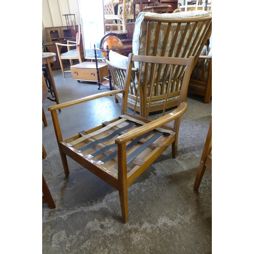 54 - A teak settee and pair of armchairs