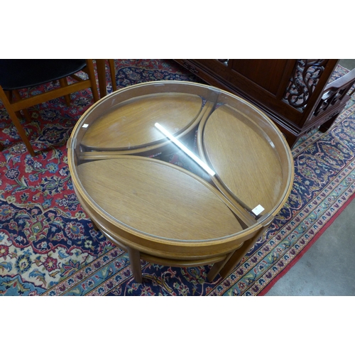 59 - A Nathan teak and glass topped circular nest of tables