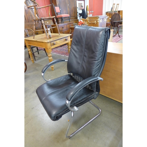 66 - A pair of black leather and chrome armchairs