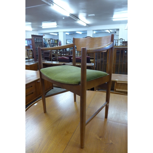 75 - A teak extending dining table and six chairs