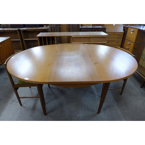 75 - A teak extending dining table and six chairs