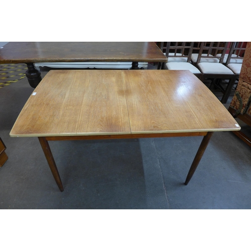 82 - A teak extending dining table