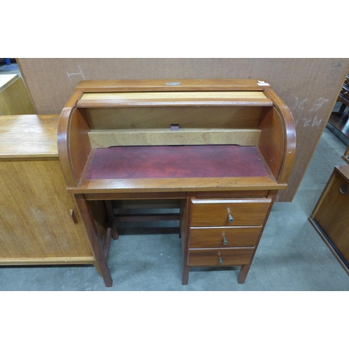 93 - A child's teak tambour roll-top desk