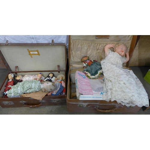 1188 - Two suitcases of dolls, a Rosebud Wonder baby doll, boxed, a Windermere & Bowness doll kit, a black ... 