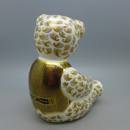 643 - A Royal Crown Derby Teddy Bear paperweight with blue bow tie, 12cm, date code for 1998, gold stopper