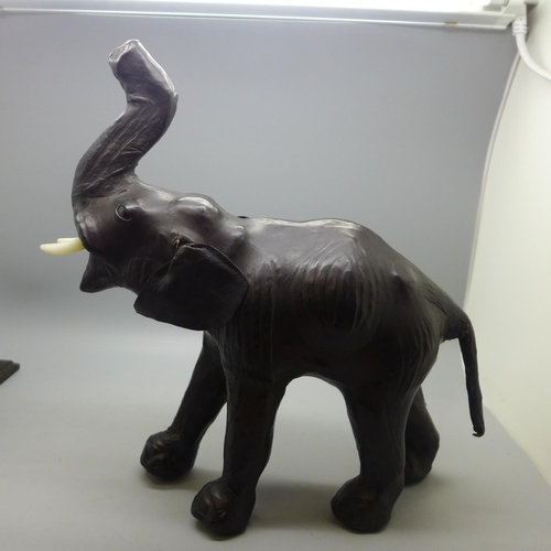 699A - A leather elephant and a pair of wooden elephant bookends