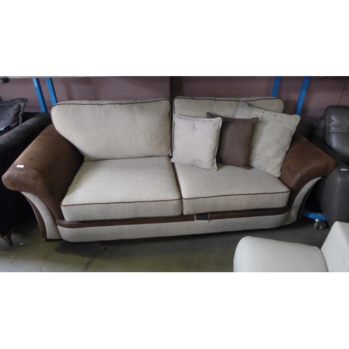 1732 - A tan and oatmeal upholstered three seater sofa