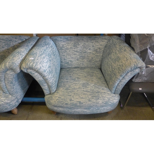 1741 - A teal and cream two seater sofa and armchair