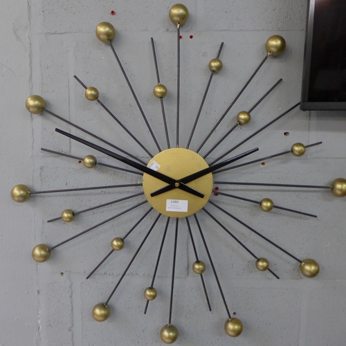 1480 - A black and gold painted star clock