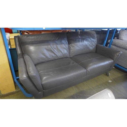 1735 - A grey leather effect two seater and three seater sofa -worn